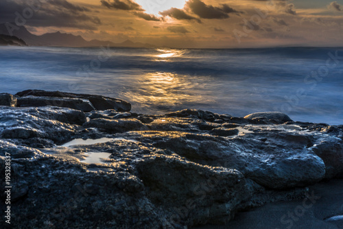 sunshine on the Atlantic Ocean with big rocks and big waves - long exposure