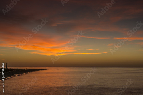 Sunrise over the Atlantic off the coast of Fuerteventura with small waves © Angela