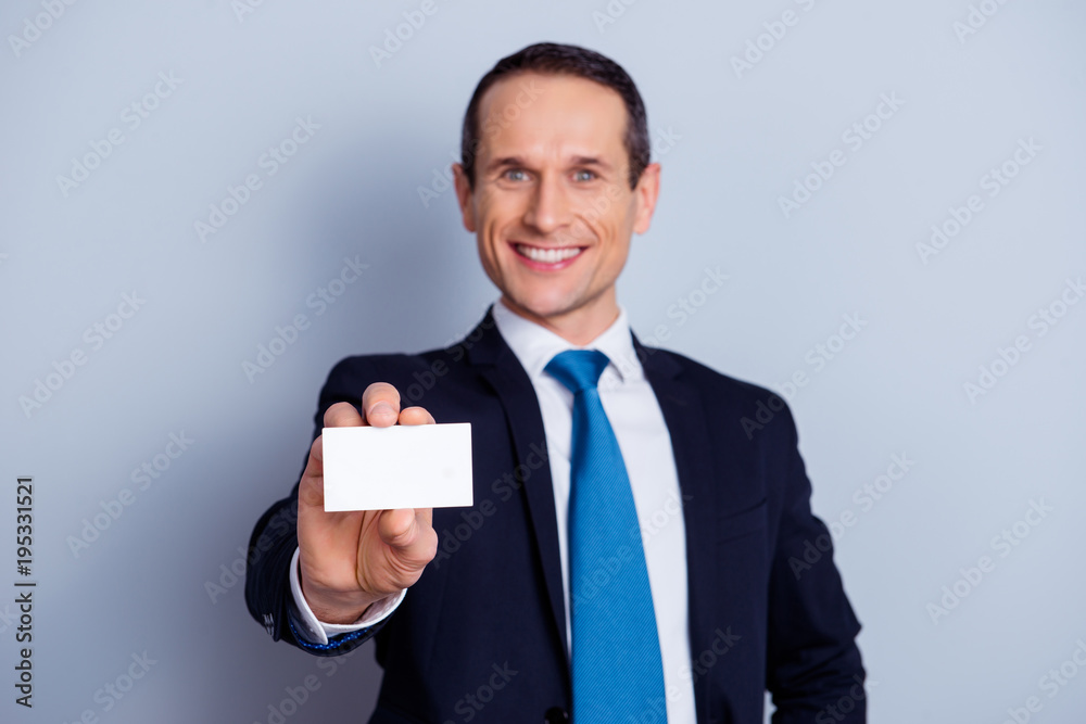 Close up portrait of friendly confident handsome leader boss chief manager demonstrating card with telephone number and address, place for text, template, isolated on gray background copyspace Close up portrait of friendly confident handsome leader boss chief manager demonstrating card with telephone number and address, place for text, template, isolated on gray background copyspace