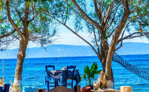 Fototapeta Naklejka Na Ścianę i Meble -  A beautiful sitting place in the shade in the Aegean Sea on the island of Lesbos directly by the sea with a view of Turkey.