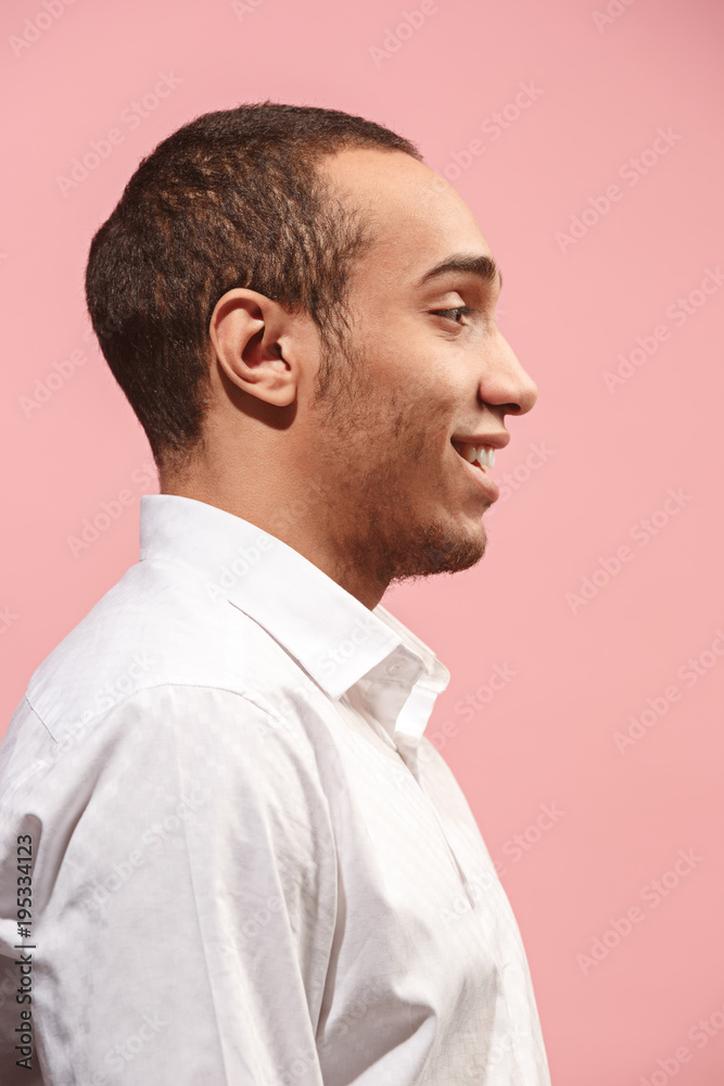 The happy businessman standing and smiling against pink background. The happy businessman standing and smiling against pink background.