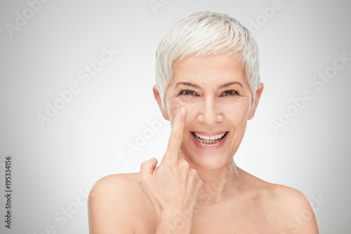 Head shot of senior woman showing wrinkles. photo