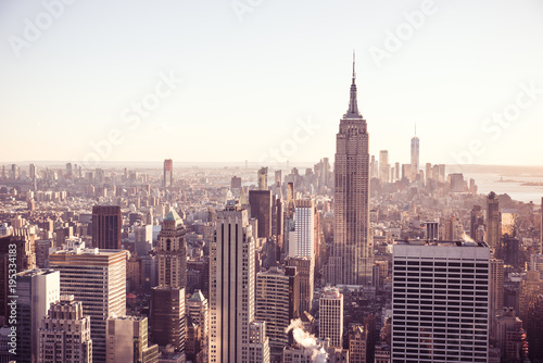 New York City - USA. View to Lower Manhattan downtown skyline with famous Empire State Building and skyscrapers at sunset. © Simon Dannhauer