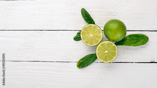Fresh Green Lime. Fruits. On a wooden background. Top view. Copy space.