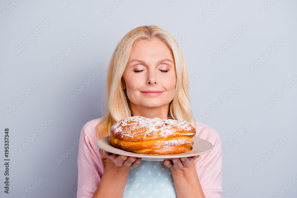 Sugar scent aroma aromatic people person concept. Close up portrait of peaceful calm satisfied cute lovely romantic with modern hairstyle granny smelling fresh tasty cake isolated on gray background Sugar scent aroma aromatic people person concept. Close up portrait of peaceful calm satisfied cute lovely romantic with modern hairstyle granny smelling fresh tasty cake isolated on gray background
