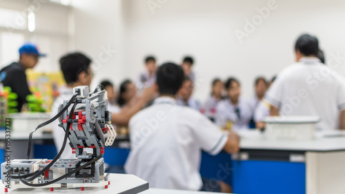Robotic lab class with school students blur background learning in group having study workshop in science technology engineering classroom for STEM education concept