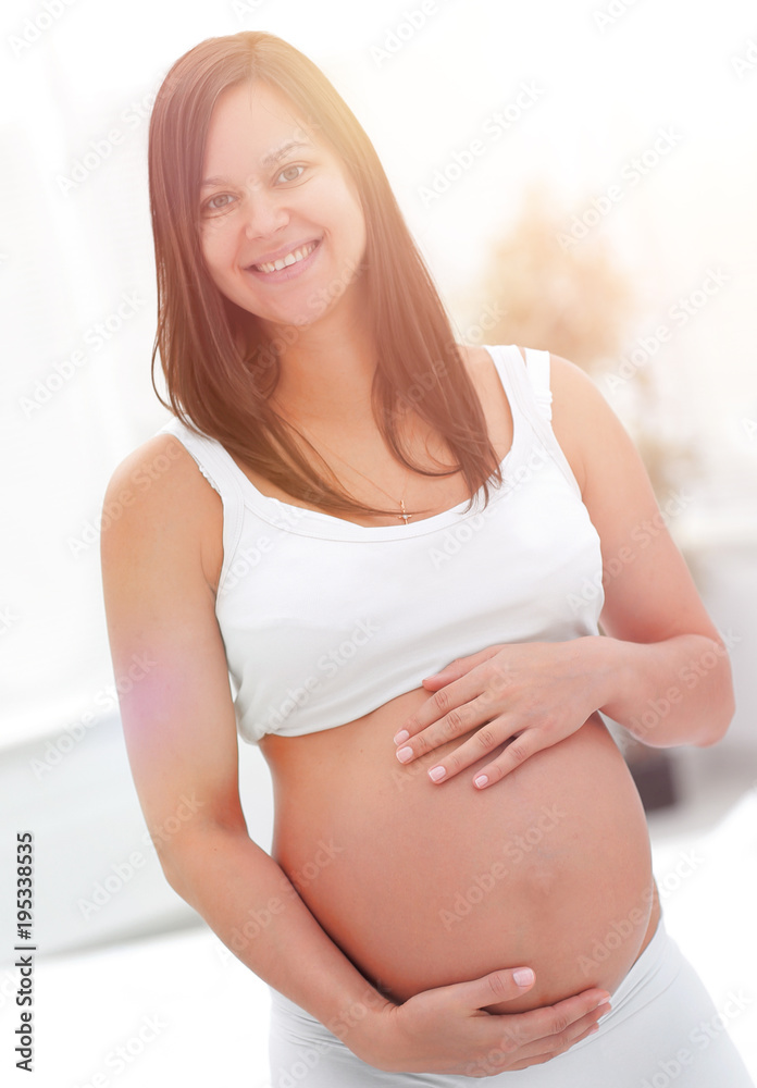 portrait of young pregnant woman on a light background. portrait of young pregnant woman on a light background.