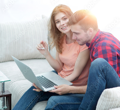 young couple watching videos on laptop