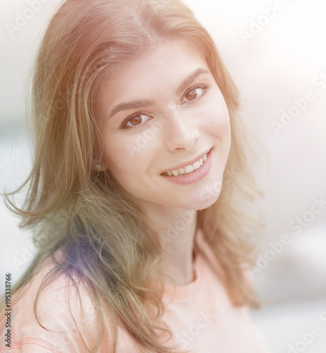 closeup portrait of a young woman on blurred background.