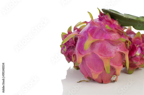 Three Dragon fruits in white background in side of the frame