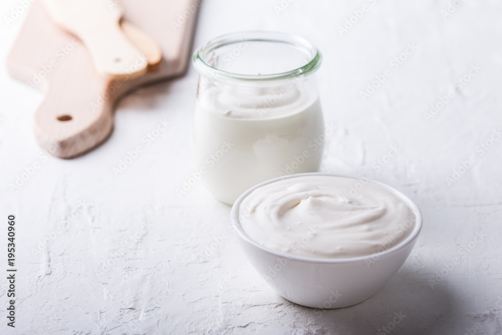 Organic sour cream in white bowl Organic sour cream in white bowl