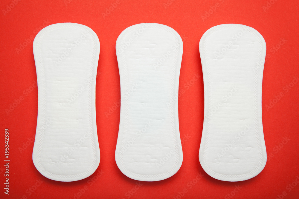Three sanitary napkins on a red background. Three sanitary napkins on a red background.