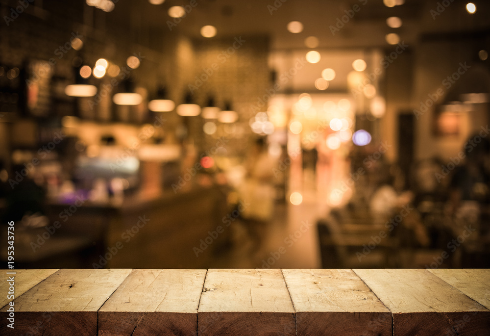 Wood table top (Bar) with blur light bokeh in dark night cafe,restaurant background