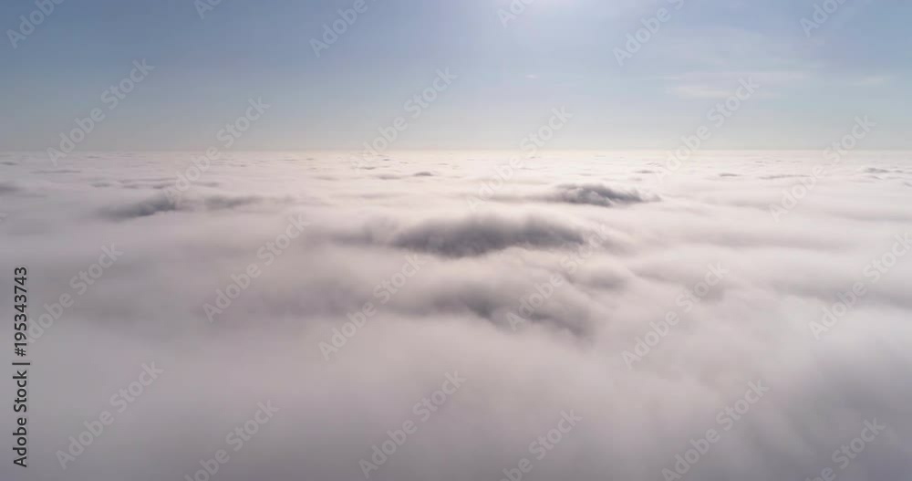 Aerial drone timelapse (dronelapse) above thick rolling clouds