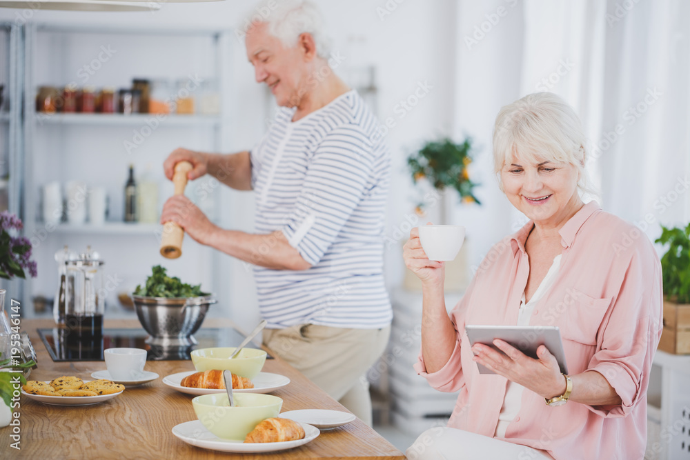 Senior woman reading digital newspaper Senior woman reading digital newspaper