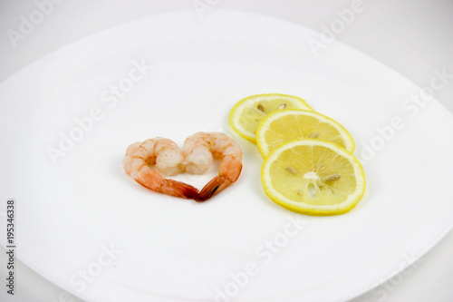 seafood. shrimp on a plate with lemon.