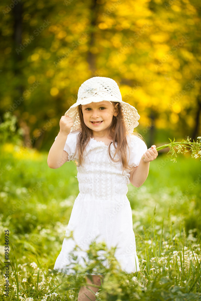 Little girl in a field with white flowers Little girl in a field with white flowers