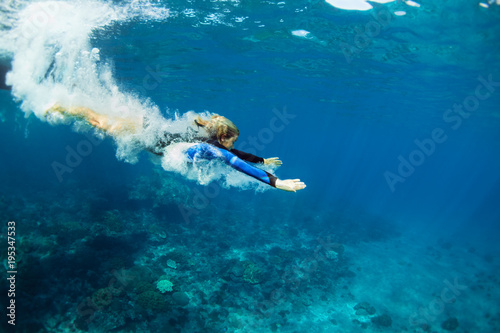 Happy family - active teenage girl jump and dive underwater in tropical coral reef pool. Travel lifestyle, water sport, snorkeling adventure. Swimming lessons on summer sea beach vacation with kids