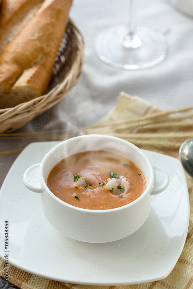 Vegetable cream soup with shrimps and croutons in white bowl close up Vegetable cream soup with shrimps and croutons in white bowl close up