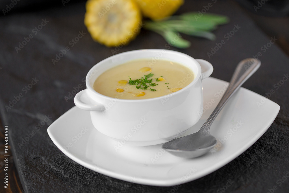 Corn soup in white cup on a table Corn soup in white cup on a table