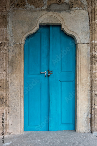 Blue door of a monastery  the color of the wood playing nicely with the color of the sandstone wall