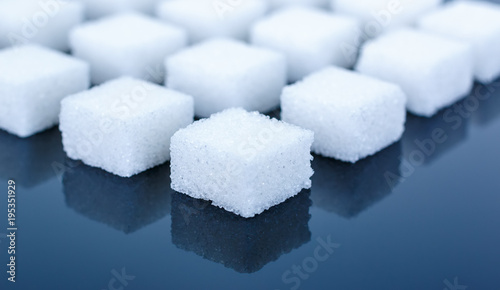 Sugar cubes mirrored on background
