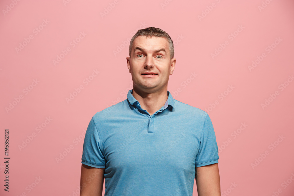 The young attractive man looking suprised isolated on pink The young attractive man looking suprised isolated on pink