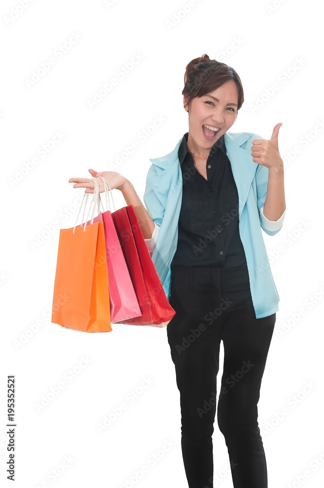 Young freshy Asian woman happy smile show thumb up in casual cloth holding color shopping bags satisfy with shopping time with blur scene shopping mall for business advertise. Young freshy Asian woman happy smile show thumb up in casual cloth holding color shopping bags satisfy with shopping time with blur scene shopping mall for business advertise.