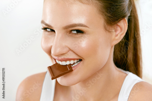 Woman Eating Chocolate. Beautiful Girl With Sweets.