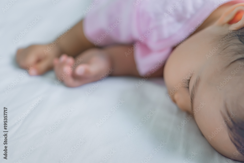 Asian baby sleeping on the bed,thailand people,relax time,selective focus Asian baby sleeping on the bed,thailand people,relax time,selective focus