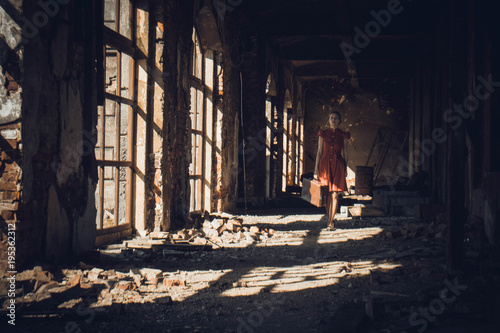 girl in red dress in old ruined brick building