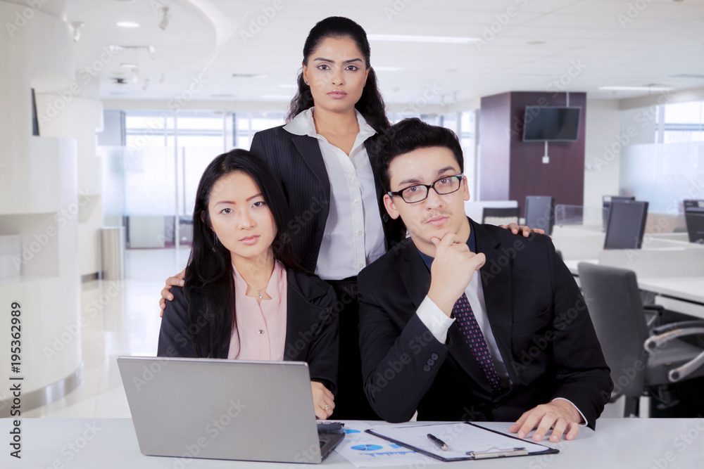 Confident business team in an office Confident business team in an office