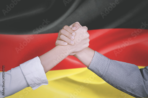 Business team hands with German flag