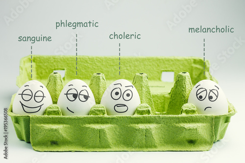 Four eggs in eggbox. Types of temperaments. Sanguine, choleric, phlegmatic and melancholic. photo