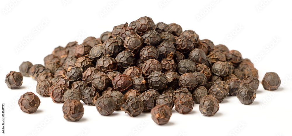 close up of dried black peppercorns isolated on white