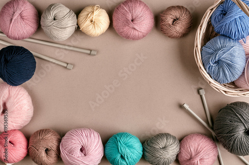 Set of colorful wool yarn on beige background. Top view. Frame of tangles of knitting threads