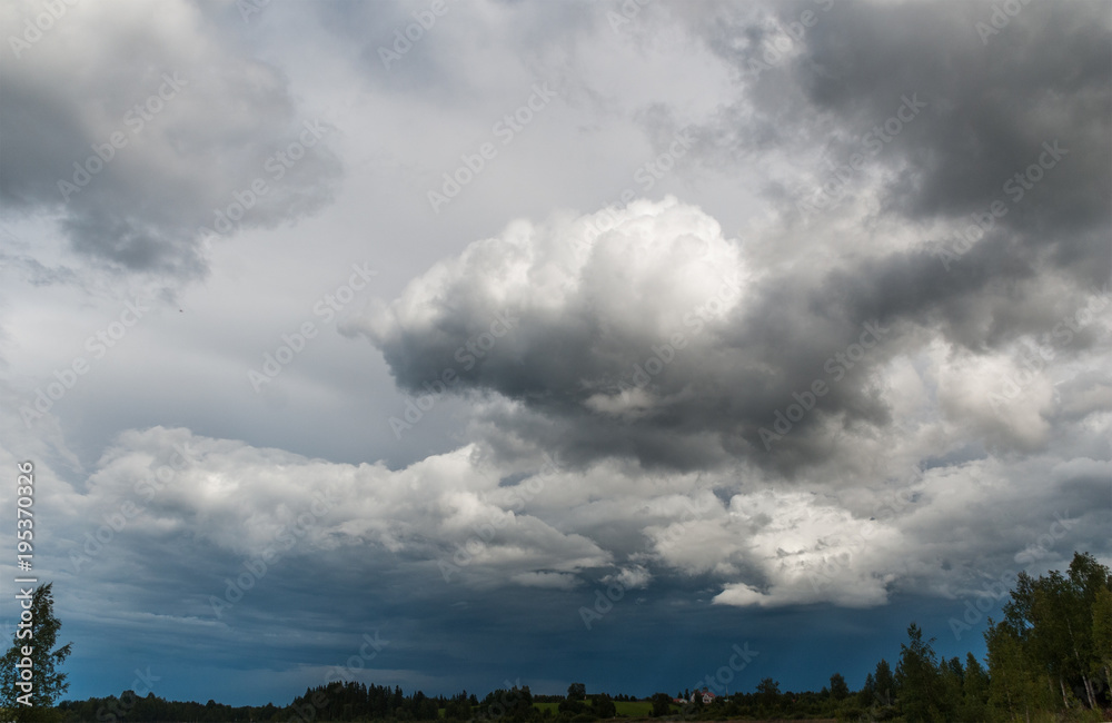 Gray and white storm clouds on a blue sky