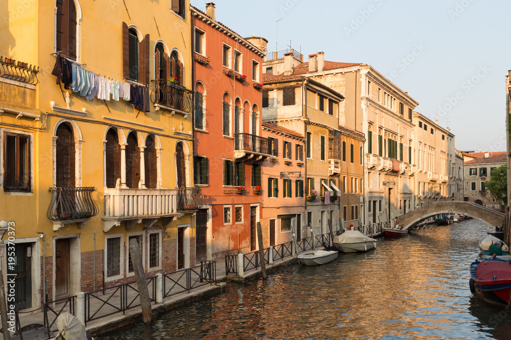Venice / Sunset view of the river canal and traditional venetian architecture