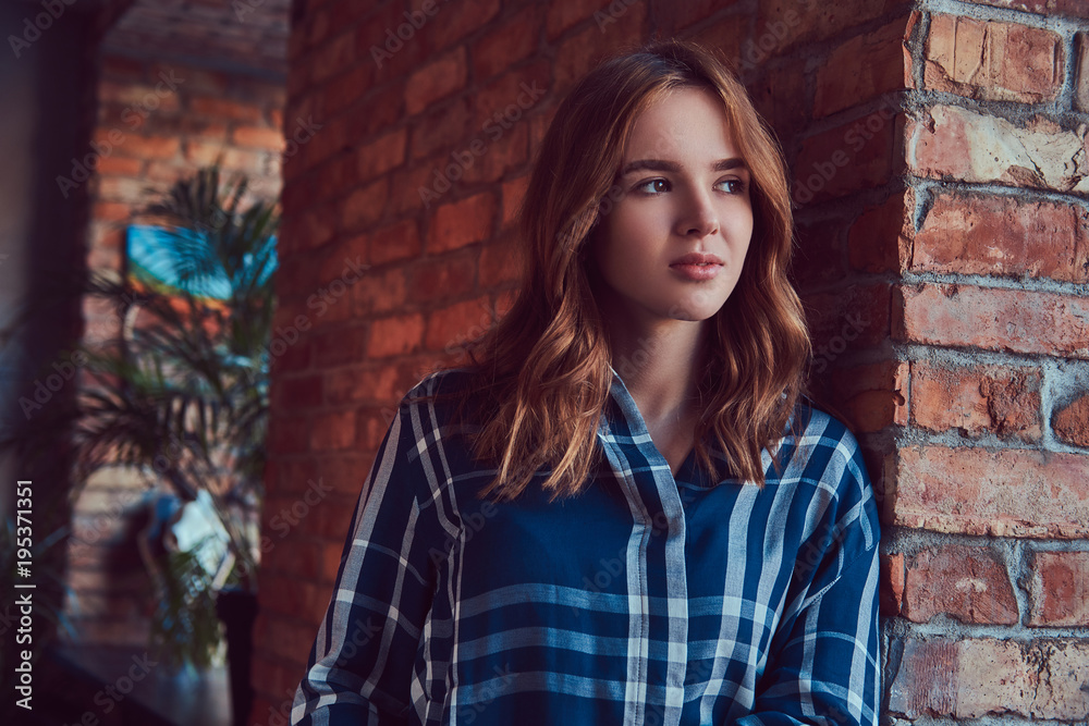 Close-up portrait of a young sensual girl leaning against a bric Close-up portrait of a young sensual girl leaning against a bric