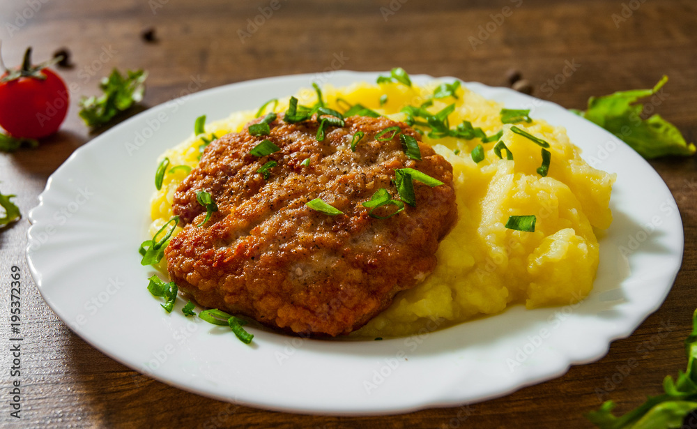burger with mashed potatoes in white plate on wooden background burger with mashed potatoes in white plate on wooden background