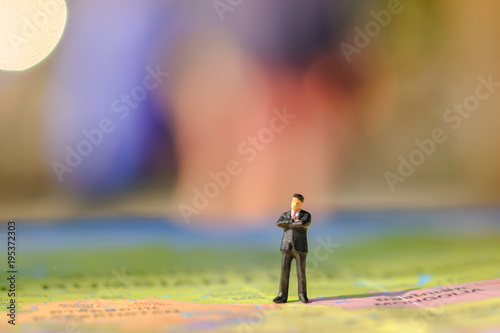 Global Business concept. Businessman miniature figure standing on world map.
