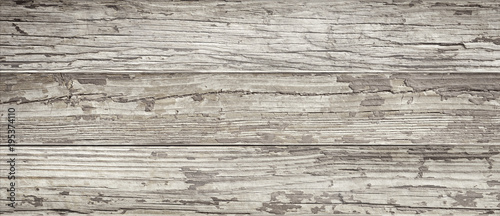Aged wooden background of weathered distressed rustic wood boards with faded paint showing brown woodgrain texture