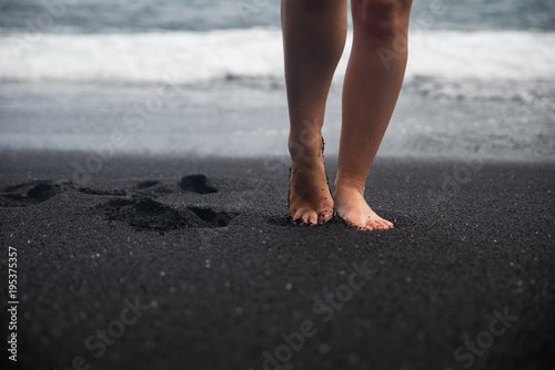 Walking On A Black Sand Beach On The Island Of Maui