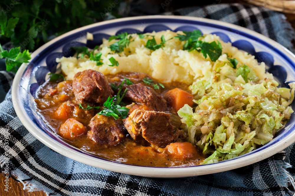 Traditional irish stew served with potatoes and cabbage Traditional irish stew served with potatoes and cabbage