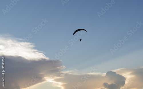 Paramotor, flying on a beautiful sky at sunset 