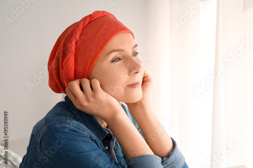 Obraz na płótnie Young woman with cancer in headscarf indoors