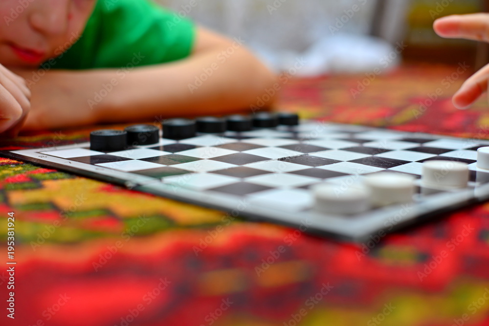 People are playing checkers close-up, the concept of a board game. People are playing checkers close-up, the concept of a board game.