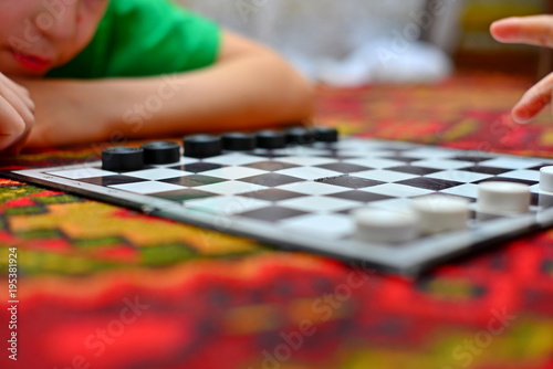 People are playing checkers close-up, the concept of a board game.