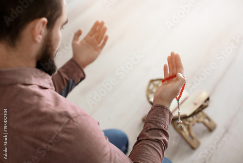 Fototapeta Naklejka Na Ścianę i Meble -  Young Muslim man praying, indoors
