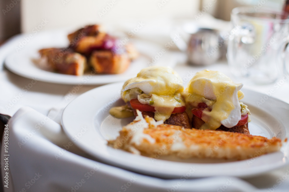 Closeup of Eggs Benedict on a Plate with Potatoes Closeup of Eggs Benedict on a Plate with Potatoes
